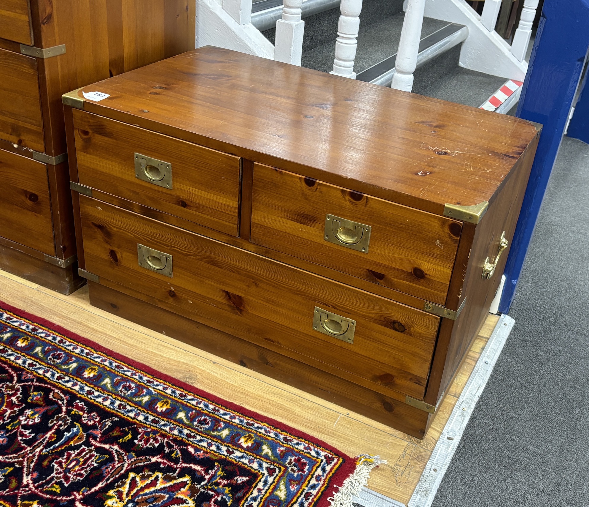 A pair of military style brass mounted pine three drawer low chests, width 77cm, depth 46cm, height 46cm